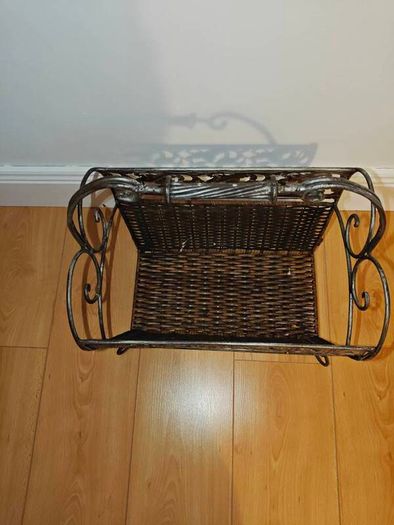 Antique iron and wicker magazine rack. Vintage antique magazine rack.