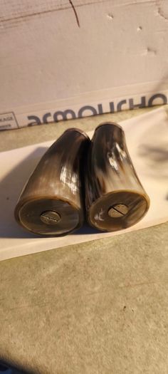 Set of 2 Buffalo Horn  Salt And Pepper Set topped with mother of pearl rimmed with sterling silver rim stamped.