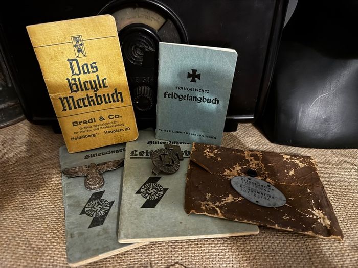 WW2 German documents with an eagle pin and an identification tag for one soldier