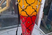 This Tall Bongo Hand Drum, a mechanical bolt tuning system with silver hardware around the top rim. The drum includes a vertical strap mechanism with Bag Stage or Movie Props