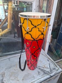 This Tall Bongo Hand Drum, a mechanical bolt tuning system with silver hardware around the top rim. The drum includes a vertical strap mechanism with Bag