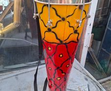 This Tall Bongo Hand Drum, a mechanical bolt tuning system with silver hardware around the top rim. The drum includes a vertical strap mechanism with Bag