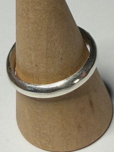 Handmade sterling silver ring with flush set stones. Size O