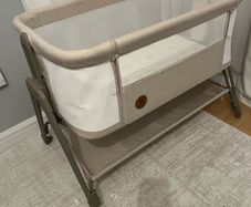 Baby beside crib