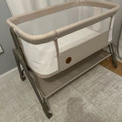 Baby beside crib