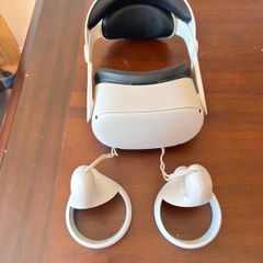 Meta Quest 2 Virtual reality headset. With 2 controllers. In near perfect condition ( barely used ). Has been restored to factory settings. Charges via usb C ( NOT included ). Original head strap was faulty so it had to be replaced.