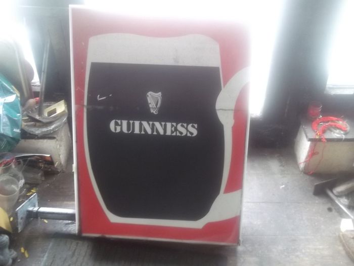 a large out door guinness item double sider