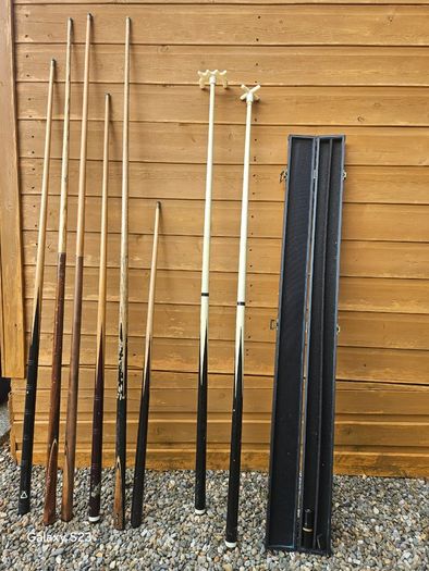 Pool cues, bridge, rest and case.