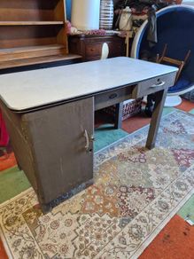 industrial steel desk featuring a light-colored laminate top