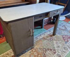 industrial steel desk featuring a light-colored laminate top