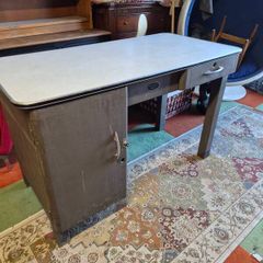 industrial steel desk featuring a light-colored laminate top