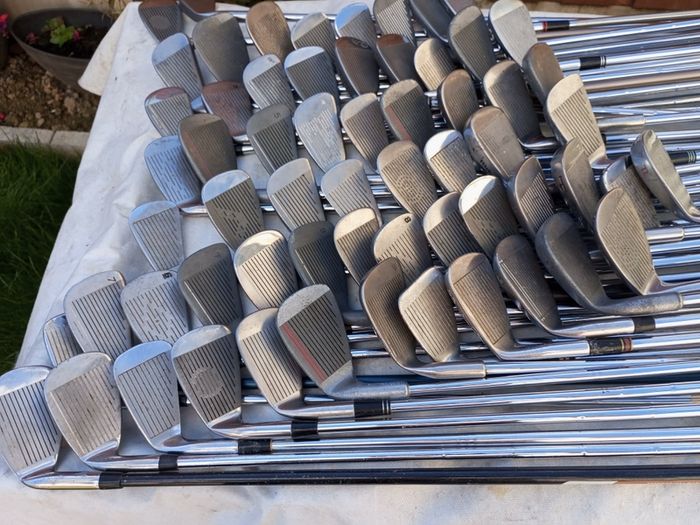 A selection of golf clubs and bags. All right handed clubs.