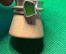Handmade sterling silver spinner ring with green sea glass. Size M