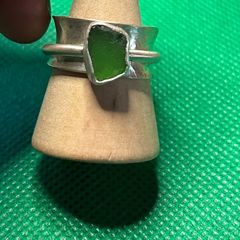 Handmade sterling silver spinner ring with green sea glass. Size M