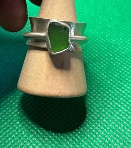 Handmade sterling silver spinner ring with green sea glass. Size M