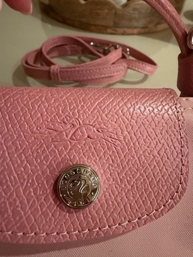 pink Longchamp Le Pliage mini top-handle bag with a detachable shoulder strap