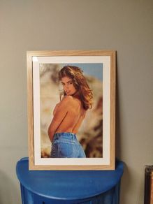 A framed vintage Cindy Crawford poster