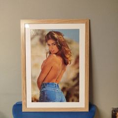 A framed vintage Cindy Crawford poster