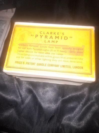 Clarkes Pyramid lamp night light and an Advertisment Box, comprising a white glazed ceramic reservoir marked Prices Patent Candle Company Limited, London