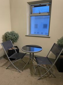 Two folding chairs and a table