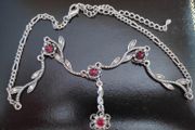 Silver tone floral necklace with red gemstone style accents