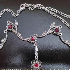 Silver tone floral necklace with red gemstone style accents