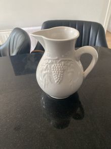 Vintage ceramic pitcher with embossed decoration