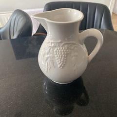 Vintage ceramic pitcher with embossed decoration