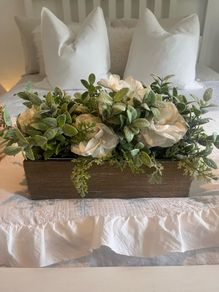Faux flower arrangement in wooden box