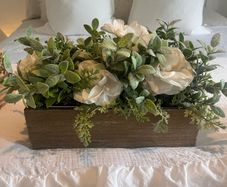 Faux flower arrangement in wooden box