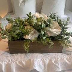 Faux flower arrangement in wooden box
