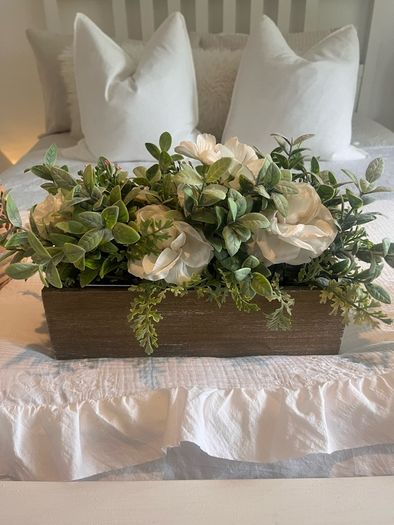 Faux flower arrangement in wooden box