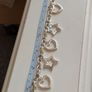 A fashionable bracelet with silver-tone charms. Image 4