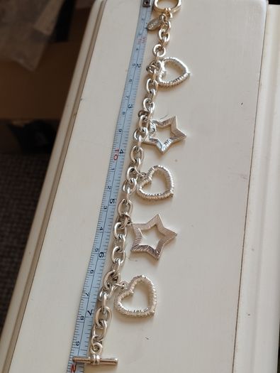 A fashionable bracelet with silver-tone charms.