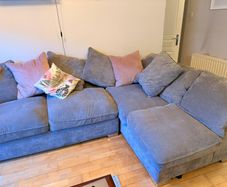 Grey corner couch incl. matching pouffe