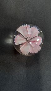 Glass paperweight with pink flower design