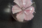Glass paperweight with pink flower design