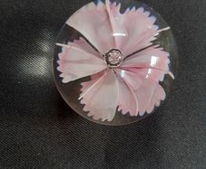 Glass paperweight with pink flower design