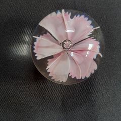 Glass paperweight with pink flower design