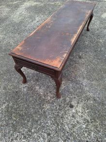 Antique wooden coffee table in need of restoration
