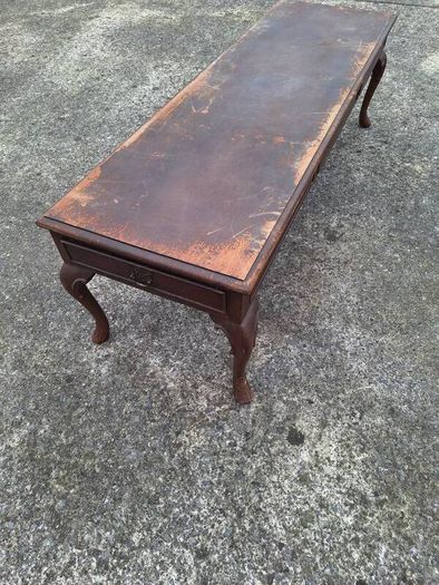 Antique wooden coffee table in need of restoration