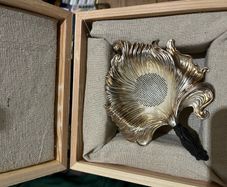 silver tea strainer in a gift box