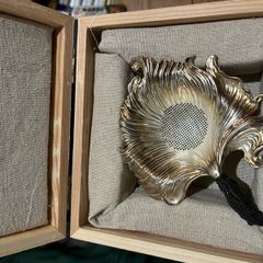silver tea strainer in a gift box