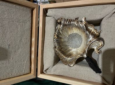 silver tea strainer in a gift box