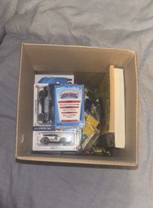 Medium cardboard box filled with toys and other bits
