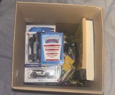 Medium cardboard box filled with toys and other bits