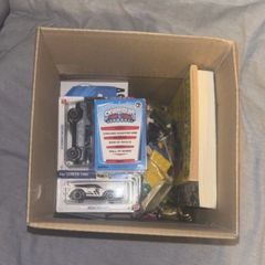 Medium cardboard box filled with toys and other bits
