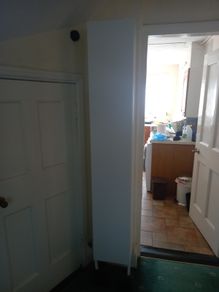 Tall white shelving unit