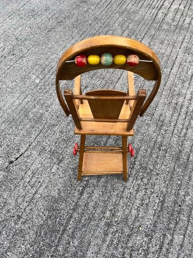 Vintage wooden doll high chair FROM THE 1930S featuring a built-in play tray with a wire bead