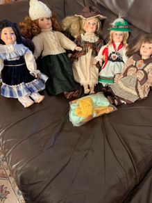 5 porcelain dolls with extra clothing perfect condition